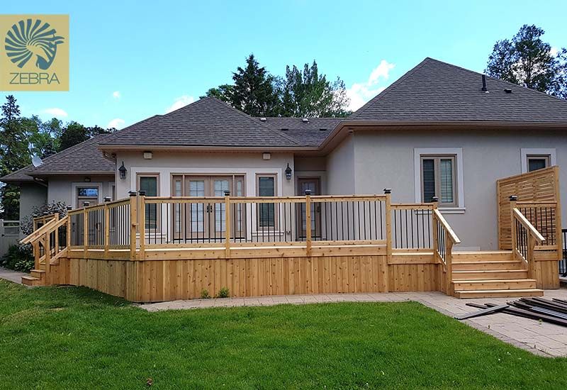 L shape cedar deck, cedar railing, black metal pickets